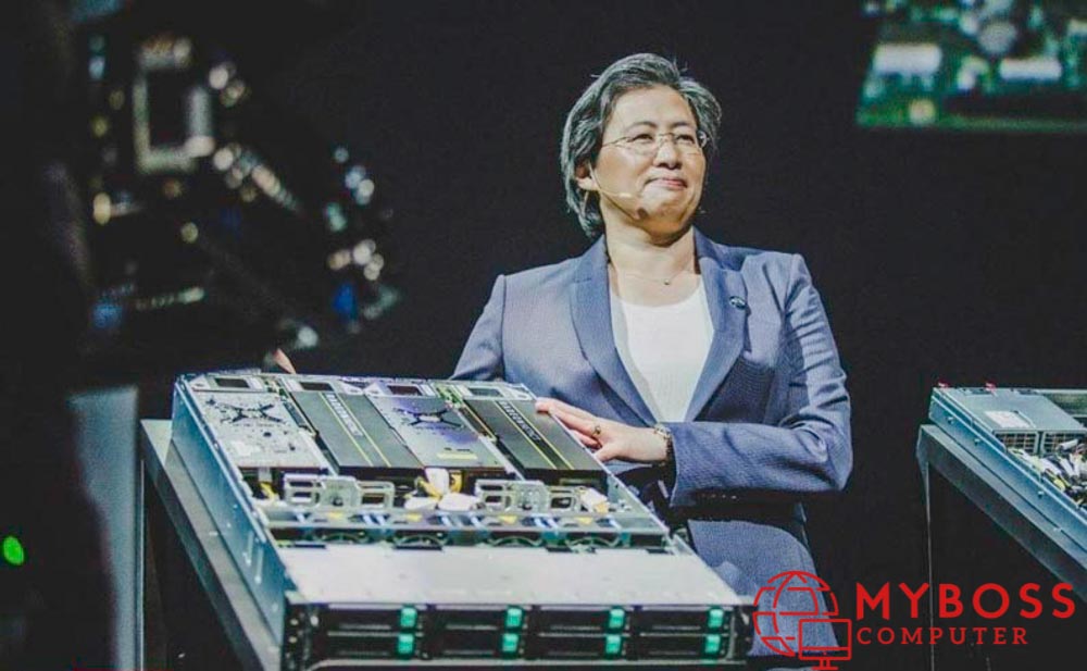Description: https://pcmax.com.vn/media/news/0503_https___blogs-images.forbes.com_patrickmoorhead_files_2018_06_A-beaming-Lisa-Su-AMD-CEO-stands-in-front-of-an-EPYC-based-server-rack-AMD-1200x800.jpg